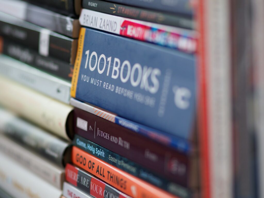 Stacked books with a focus on "1001 Books You Must Read Before You Die," highlighting curated literary recommendations.